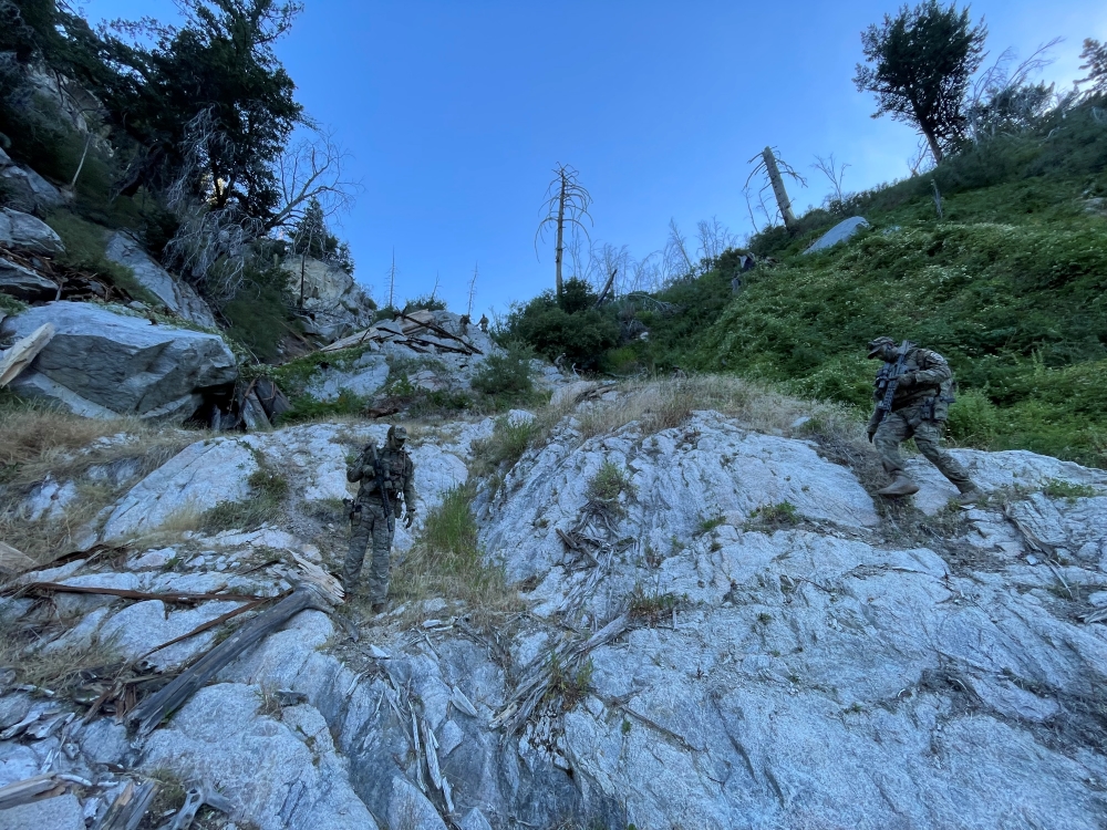 MET officers climbing down a steep cliff at dawn while investigating illegal cannabis cultivation in Los Angeles County